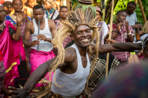 Man wearing a traditional fiber headdress dancing with musicians and onlookers outdoors.